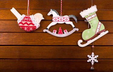 The Christmas decoration toys over wooden background.