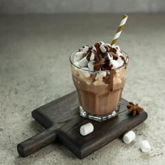 Cup of hot chocolate with marshmallow on a grey background .  Hot chocolate  in a glass.  Cocoa drink . Low key .