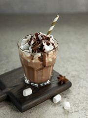 Cup of hot chocolate with marshmallow on a grey background .  Hot chocolate  in a glass.  Cocoa drink . Low key .