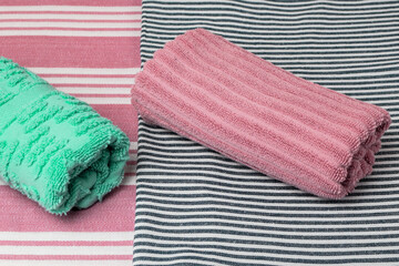 Bright bath towels on a colored background. Top view.