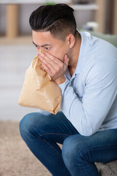 man having panic attack at home