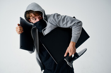 male thief hooded head hacking technology security light background