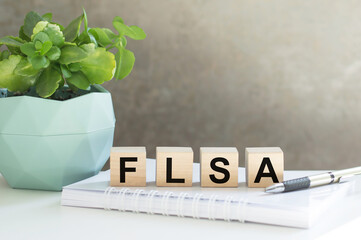 FLSA, text on wood cubes on light background, business concept
