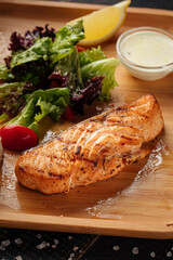 Top view on grilled salmon steak with rice on wooden board 