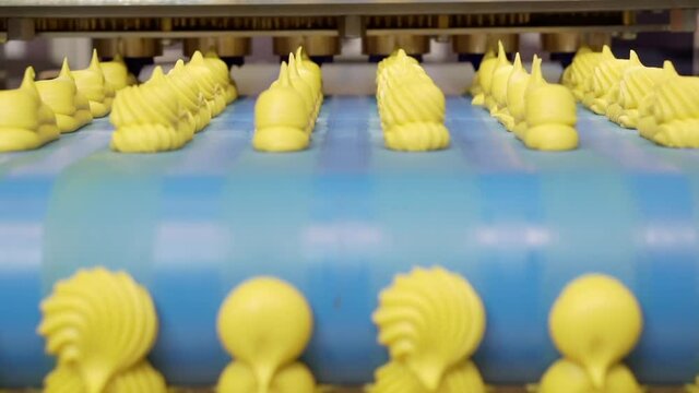 Moving confectionery along a conveyor line.