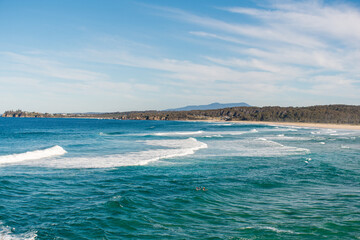 Ocean waves and sandy beach on a sunny day. Nature tropical paradise background. Tuross Head, NSW, Australia