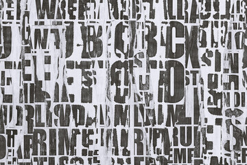 Collage of torn street posters. Abstract black and white  lettering background.