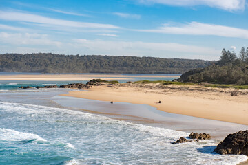 Ocean waves and sandy beach on a sunny day. Nature tropical paradise background. Tuross Head, NSW, Australia