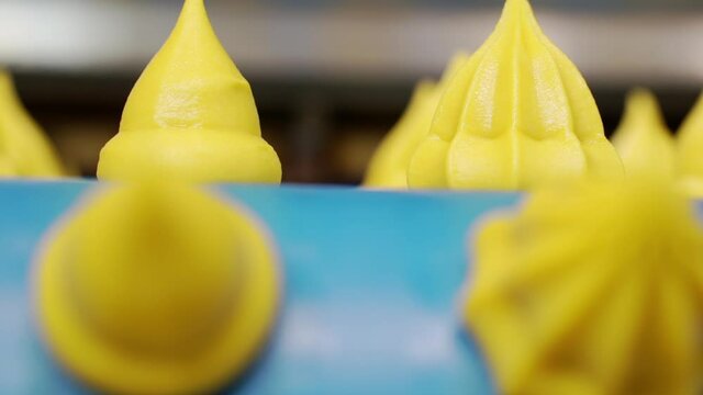 Moving confectionery on a conveyor line close-up.