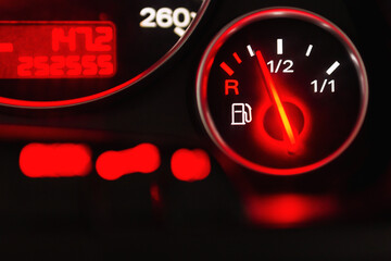 Fuel gauge with speedometer red indicator at empty level.Close-up car dash board petrol meter, fuel...