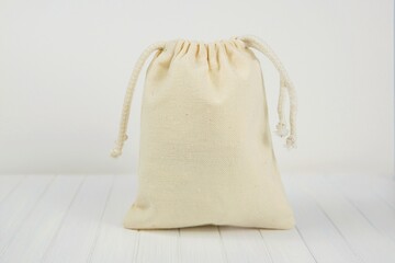 Small canvas sack, muslin drawstring favor or gift bag mockup for design presentation.