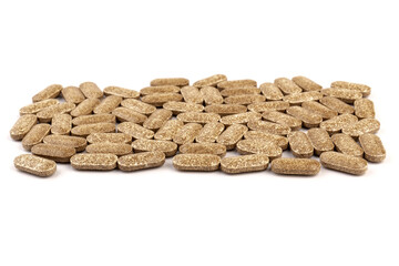 Nutrition supplements, brown vitamin pills on white background.