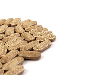 Nutrition supplements, brown vitamin pills on white background.