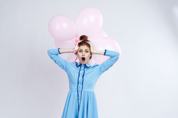 cheerful woman in a blue dress pink balloons holiday birthday