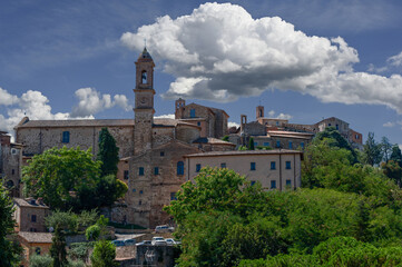 Fototapeta na wymiar Montepulciano, Tuscany, Italy. August 2020. View of the historic center, recognizable the bell tower of the church of Sant'Agostino. Beautiful summer day.