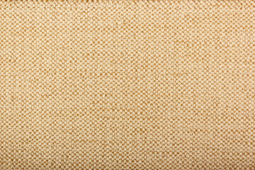 Fototapeta premium Factory fabric with brown and white threads interspersed. Close-up long and wide texture of natural fabric. Fabric texture of natural cotton or linen textile material.