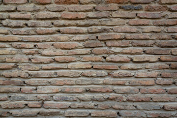 Red background of old vintage brick wall texture. Close up view of old stone brick wall with medieval masonry,