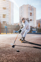 Working with a hockey stick and puck outside the ice on inline skates - rubber coating outdoors for...