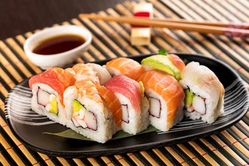 Foto auf Acrylglas Set of rainbow uramaki sushi rolls with avocado © photology1971