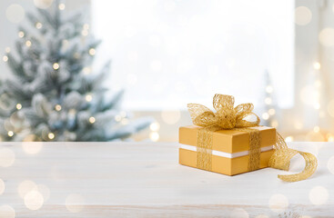 Gift box on table with space on blurred Christmas background