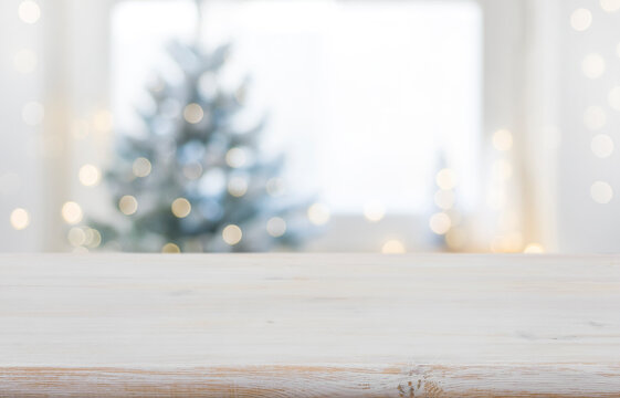 Empty wooden table in front of blurred winter festive background