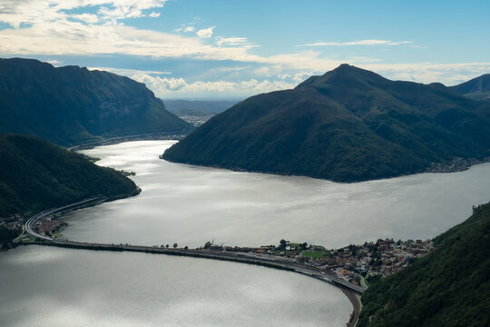 Lugano, Switzerland - October 6th 2021: View from Monte San Salvatore toward the dam between Melide and Bissone separating the lake into two parts.
