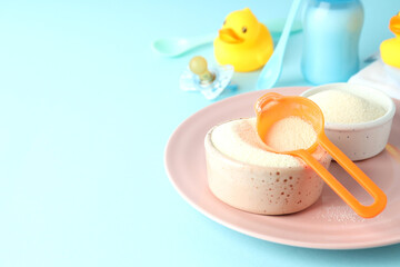 Concept of baby food with рowdered milk on blue background