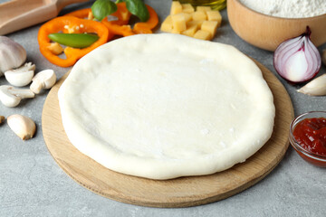 Concept of cooking pizza on gray textured background