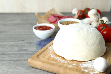 Concept of cooking pizza on gray wooden table
