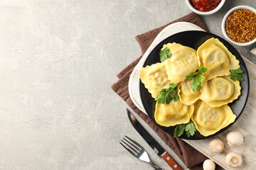 Delicious food concept with ravioli on gray background