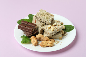 Concept of tasty food with halva on purple background