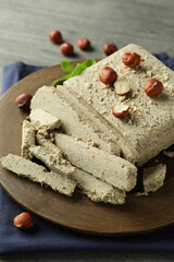 Concept of tasty food with halva on gray wooden background