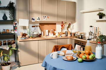 Image of dining table with food and drinks for breakfast in the kitchen at home