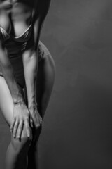Obraz premium Sensual beautiful woman posing over grey background, black and white