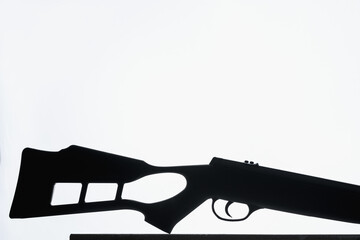 Silhouette of weapons on a gray background. Part of a rifle on a stand. Armed Forces Concept