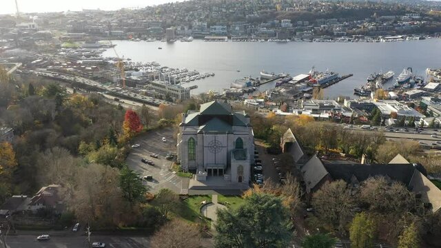 Cinematic 4K aerial drone orbiting footage of Saint Mark's Episcopal Cathedral on Capitol Hill, Eastlake, Lake Union, Union Bay near downtown Seattle, Washington