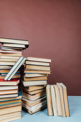 stacks of educational books in the library on a brown background