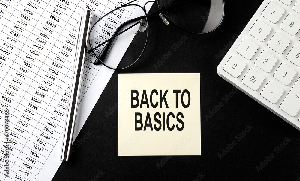 Poster concept back to basics message on sticker with glasses,chart and calculator on the black background