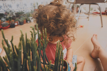 Cute baby caring the plants in home