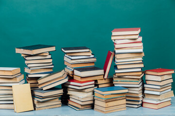 stacks of books in the university library on a green background
