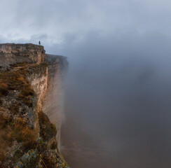 A girl standing on the edge of a cliff. White rock. Crimea