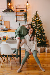 Happy young woman with cute teenage daughter in christmas interior.