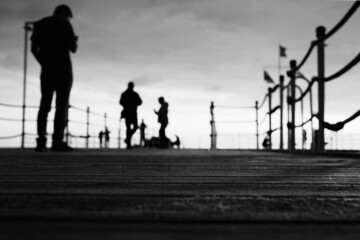 Fototapeta na wymiar people on the pier, black and white photo