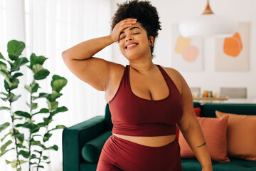 Plakat Body positive woman taking break from workout at home
