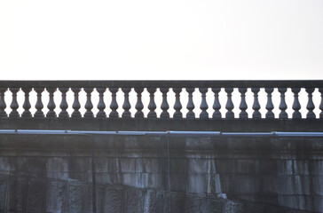 Stone Balustrade on Old River Bridge on Misty Autumn Morning 