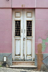 Fototapeta na wymiar Old Wooden Door in Pink Painted Wall