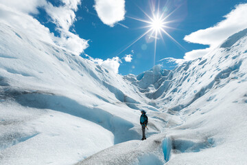 Naklejka na ściany i meble A man walking on the ice formation of the Perito Moreno Glacier