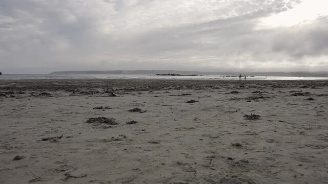 Clouds over Marazion Beach at St Michael's Mount in Cornwall near Penzance - Slow Motion with People Playing in the Background