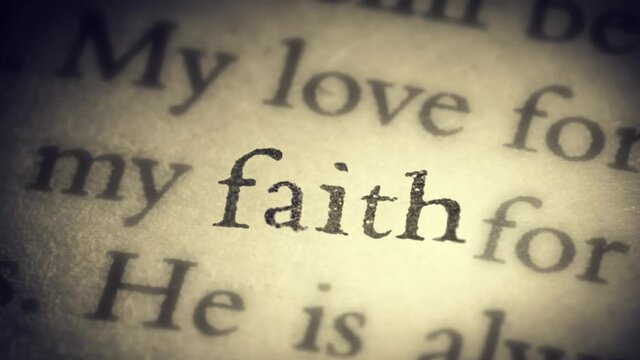 The word faith on an old page in the book is separated from the general text and zooms into the camera. Creative 3D 4k slow motion video animation.