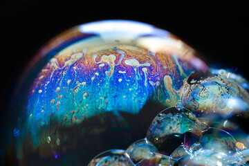 Abstract pattern, multicolored chaotic texture inside of the soap bubble, closeup